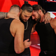 Dean Ambrose, Roman Reigns, and Seth Rollins embrace on Monday after Reigns announced that he’s been diagnosed with a relapse of leukemia.